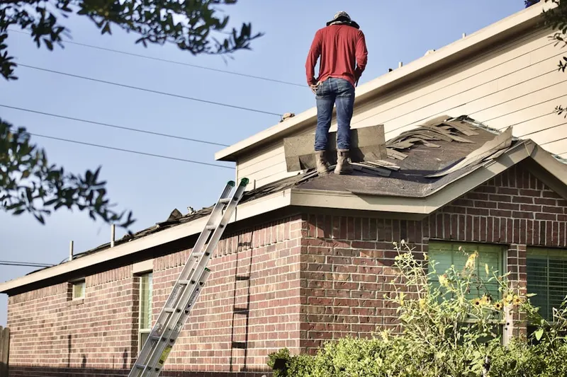 Professional roofer working on a residential roof in Downtown Portland